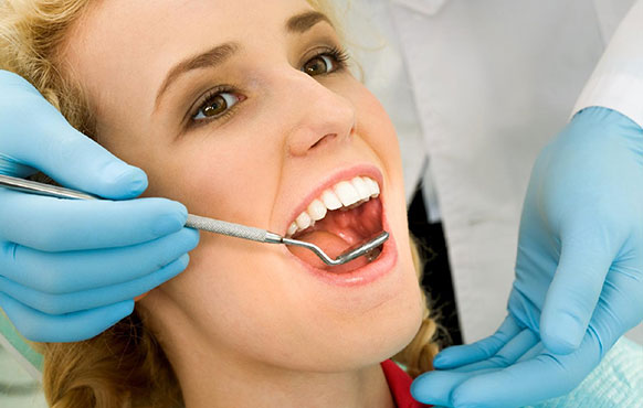 Close up photo of a woman having a dental exam